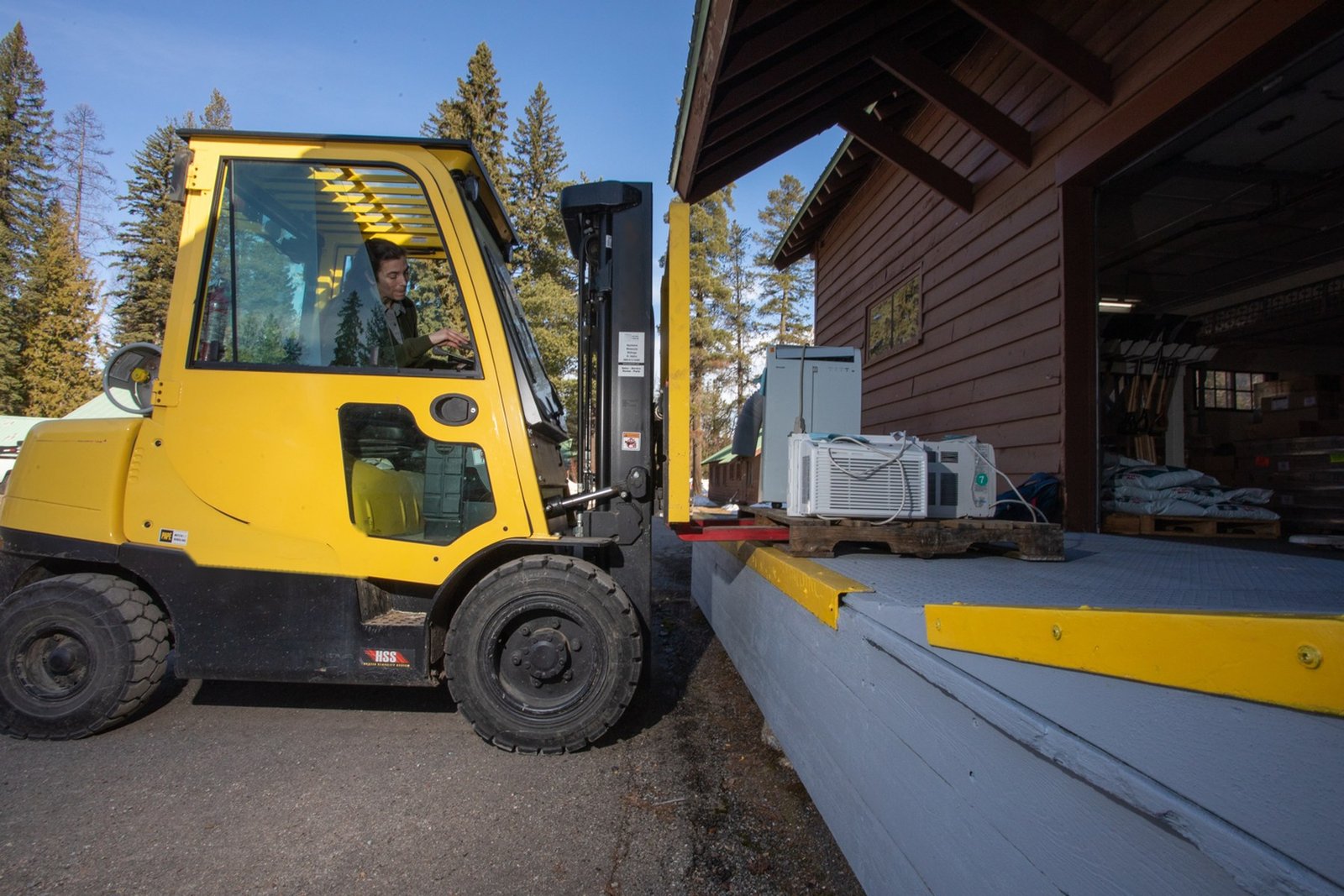 Forklift handling materials at a loading dock